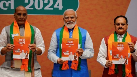 Indian Defence Minister Rajnath Singh, Prime Minister Narendra Modi and President of the Bharatiya Janata Party J. P. Nadda display copies of the ruling Bharatiya Janata Party's (BJP) election manifesto for the general election, in New Delhi, India, April 14, 2024. REUTERS/Adnan Abidi