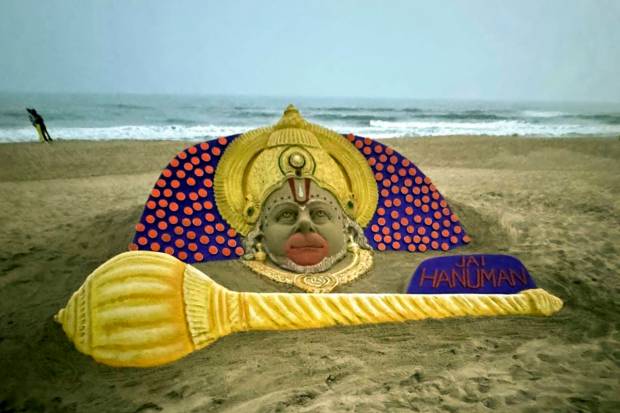 Sand artist Sudarshan Pattanaik creates a sand art on 'Hanuman Jayanti' at Puri beach. (PTI Photo)