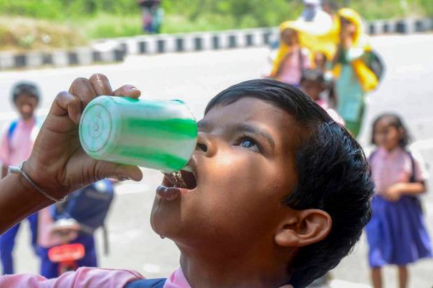 A student drinks water on a hot summer day, in Ranchi (PTI Photo)