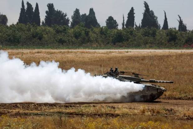 An Israeli tank manoeuvres near the Israel-Gaza border, amid the ongoing conflict between Israel and the Palestinian Islamist group Hamas, as seen from Israel. REUTERS