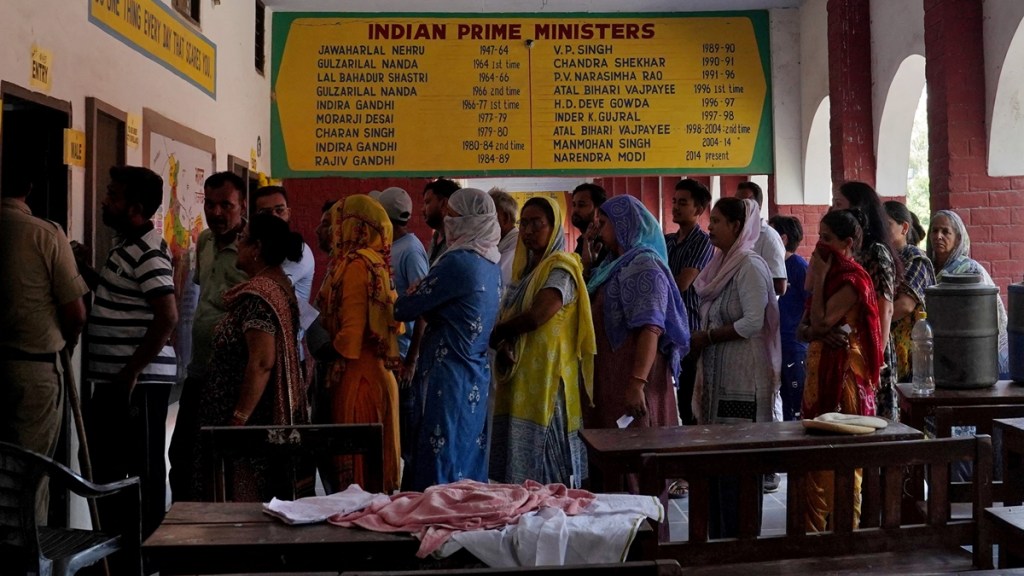 Maharashtra Exit Poll Result Date and Time: People wait in lines to cast their votes. (Reuters/File)