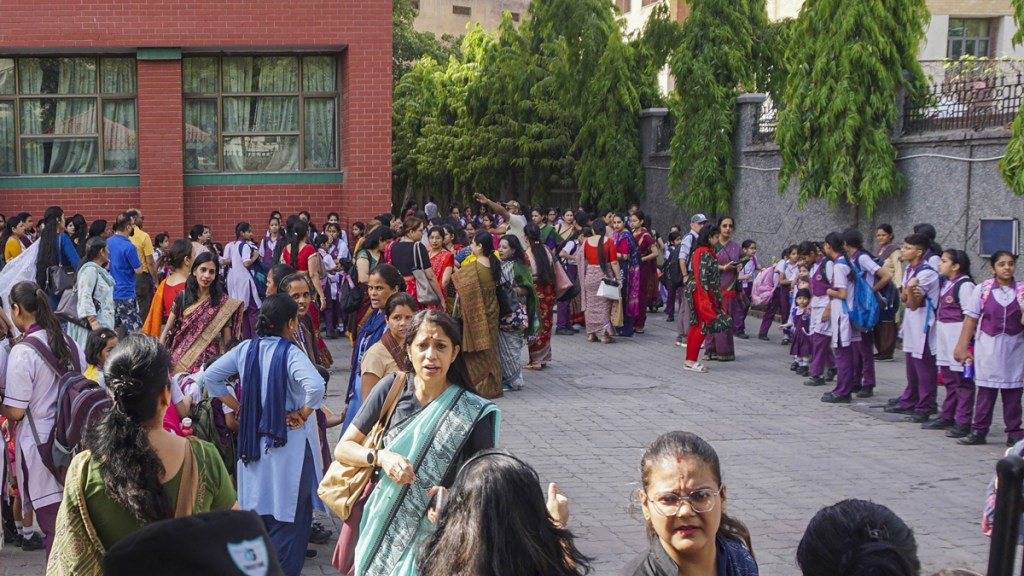 School children, teachers and others at Mother Mary’s School at Mayur Vihar, in New Delhi, Wednesday, May 1, 2024. Panic gripped schools in the national capital and adjoining Noida after six of them received bomb threats here on Wednesday morning, police officials said. (PTI Photo)