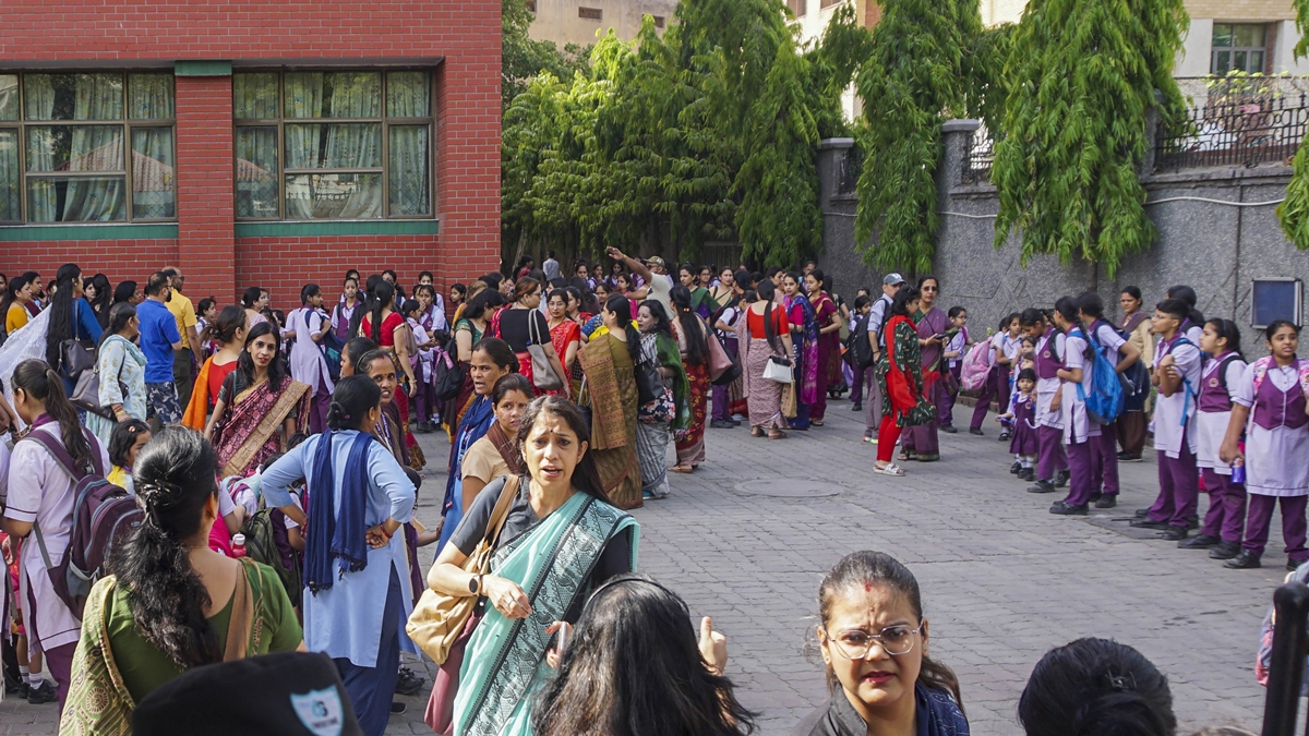 School children, teachers and others at Mother Mary’s School at Mayur Vihar, in New Delhi, Wednesday, May 1, 2024. Panic gripped schools in the national capital and adjoining Noida after six of them received bomb threats here on Wednesday morning, police officials said. (PTI Photo) School children, teachers and others at Mother Mary’s School at Mayur Vihar, in New Delhi, Wednesday, May 1, 2024. Panic gripped schools in the national capital and adjoining Noida after six of them received bomb threats here on Wednesday morning, police officials said. (PTI Photo)