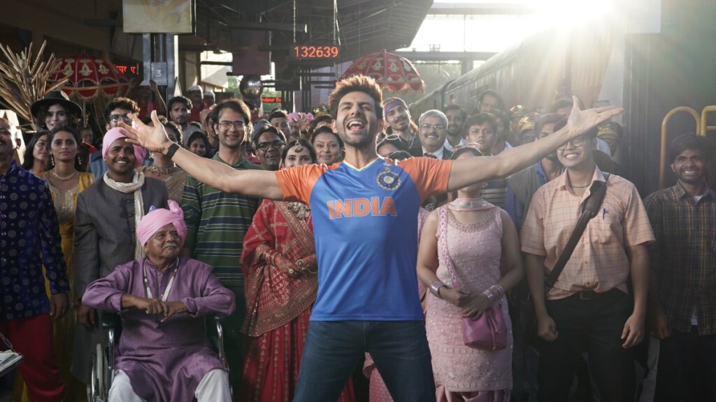 The ad film opens with a shot of a railway station platform and Kartik Aaryan in a Team India jersey making an announcement