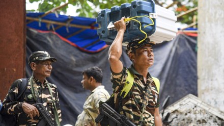 Security personnel with the Electronic Voting Machines (EVM) and other election material leave from a distribution center for their respective polling booths, on the eve of the seventh and last phase of the Lok Sabha elections, in Patna, Friday, May 31, 2024. (PTI Photo)