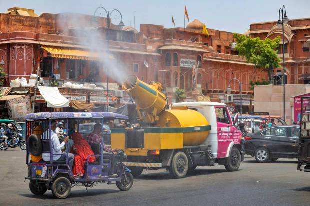 A vehicle of the Jaipur Municipal Corporation Heritage sprays water mist to provide relief from the scorching sun on a hot summer day, in Jaipur. (PTI Photo)