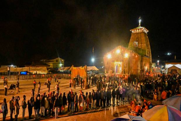 Devotees wait in a queue to offer prayer at the Kedarnath Temple during Char Dham Yatra, in Rudraprayag district. (PTI Photo)