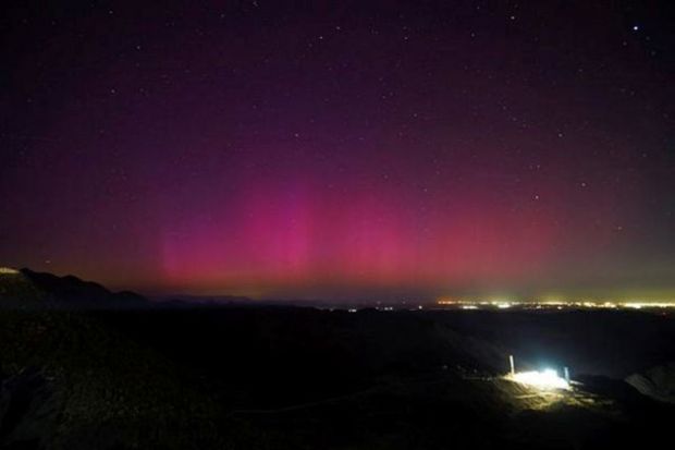 A view shows the lights of an Aurora Borealis caused by a geomagnetic storm over the border cities of Mexicali, Mexico and Calexico, U.S. as seen from Tecate, Mexico.