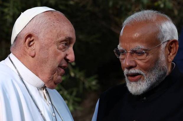 Pope Francis speaks with India's Prime Minister Narendra Modi as G7 leaders and representatives of States and International Organisations gather for a family photo on the second day of the G7 summit at the Borgo Egnazia resort, in Savelletri, Italy. REUTERS