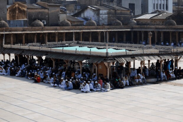 On June 17, 2024, during the Eid-ul-Adha celebration in Ahmedabad, India, Muslims waited for the commencement of prayers at a mosque while sitting in the shade to shelter themselves from the heat. (Reuters)