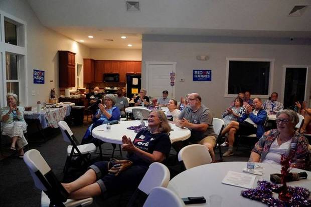 People react while watching the live debate on screen in North Carolina. (Photo source: Reuters)