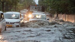 Vehicles wade through a waterlogged road amid rains, in New Delhi, Friday morning, June 28, 2024. (PTI)
