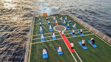 Indian Coast Guard (ICG) personnel perform yoga aboard ICG’s ship Samarth during preparations on the eve of the International Day Of Yoga. (PTI)