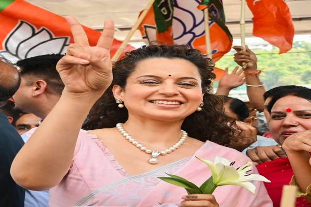 BJP candidate Kangana Ranaut shows victory sign during celebrations as she leads amid counting of votes for Lok Sabha elections, in Mandi, Tuesday, June 4, 2024. (PTI Photo)