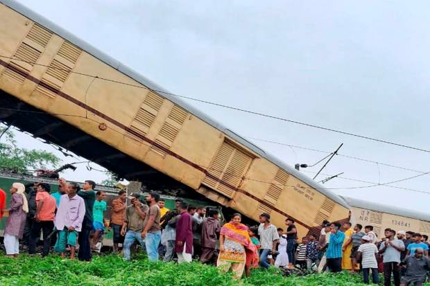 Locals gather after the Kanchanjungha Express collided with a goods train, near New Jalpaiguri railway station, on Monday, June 17, 2024. (PTI Photo)