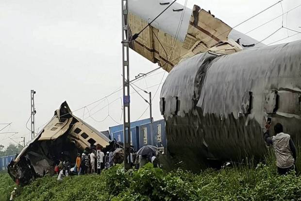 Locals gather after the Kanchanjungha Express collided with a goods train, near New Jalpaiguri railway station, on Monday, June 17, 2024. (PTI Photo)