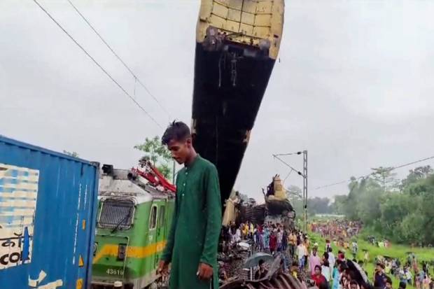 Locals gather after a collision between the Kanchanjungha Express and a goods train, near Rangapani railway station, on Monday, June 17, 2024. (PTI Photo)