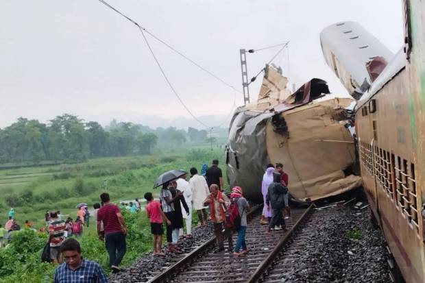Locals gather after a collision between the Kanchanjungha Express and a goods train, near Rangapani railway station, on Monday, June 17, 2024. (PTI Photo)