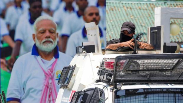 A security personnel guards near the SKICC on the eve of the International Day of Yoga, in Srinagar on Thursday. Security has been tightened in the city and the parts of Kashmir Valley ahead of the visit of Prime Minister Narendra Modi to attend Yoga Day events. (PTI)