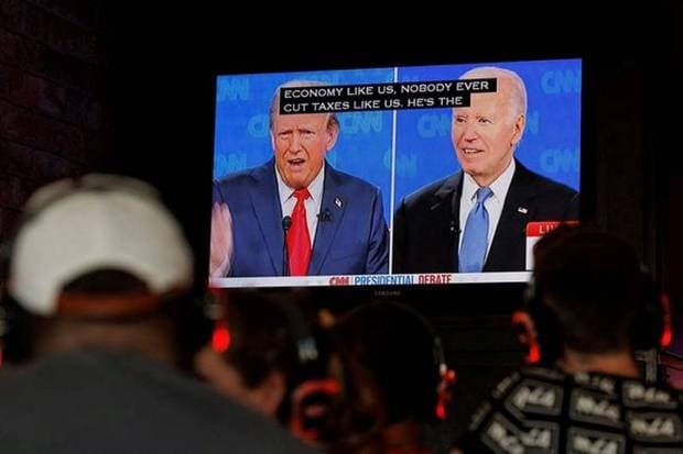 People watching the presidential live debate between US President Joe Biden and Republican candidate Donald Trump in California on June 27, 2024. (Photo source: Reuters)