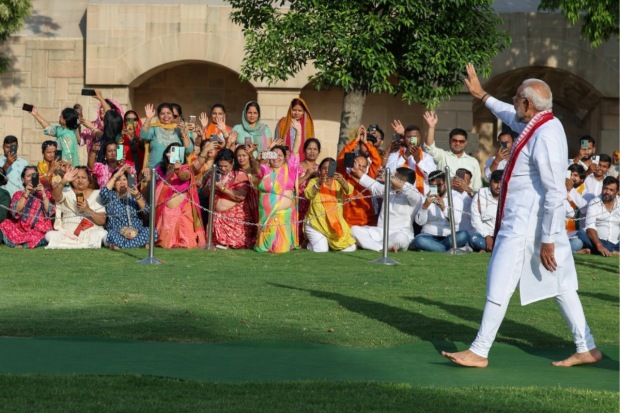 Modi makes a gesture in New Delhi to acknowledge the people after honouring Mahatma Gandhi on Sunday, June 9 (Photo: X/@narendramodi)