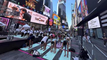 People participate in a mass yoga session at Times Square organised by the Consulate General of India, in New York. (PTI)