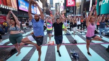 People practice yoga during the 22nd annual 