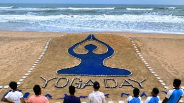 Renowned sand artist Sudarsan Pattnaik has creates a sand art on the eve of Yoga Day, at Puri beach in Odisha. (PTI)