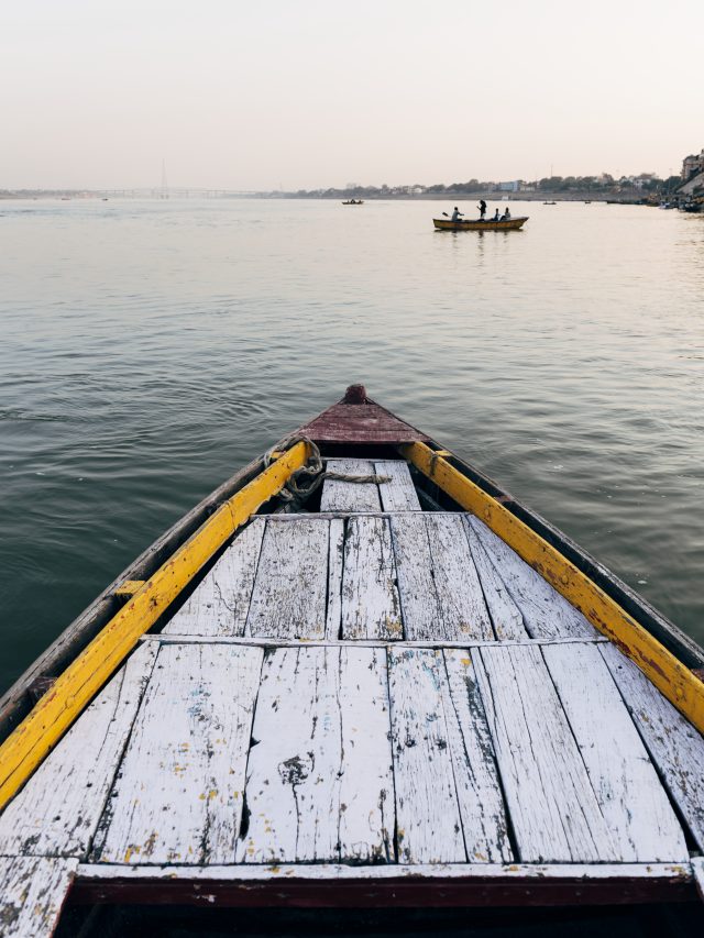 Wooden boat sailing on the River Ganges in Varanasi, India