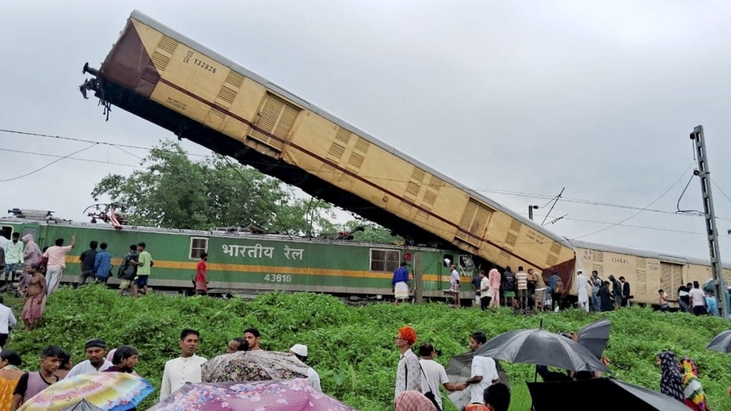 Locals gather after the Kanchanjungha Express collided with a goods train, near New Jalpaiguri railway station, on Monday, June 17, 2024. (PTI Photo) Locals gather after the Kanchanjungha Express collided with a goods train, near New Jalpaiguri railway station, on Monday, June 17, 2024. (PTI Photo)