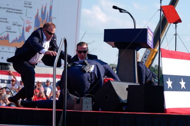 U.S. Secret Service agents converge to cover Republican presidential candidate former President Donald Trump at a campaign rally in Butler, Pennsylvania, where he was shot at.(Photo: AP/PTI)