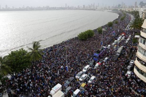 Fans gather outside the Wankhede Stadium ahead of the arrival of India's T20 World Cup-winning cricket team through an open bus victory parade. (PTI)