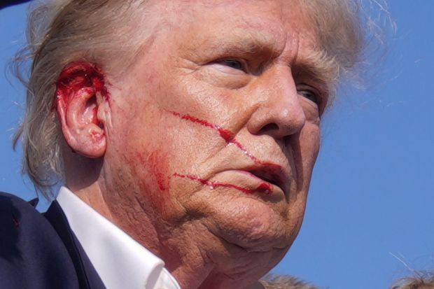 Blood visible from Trump's ear as the Secret Service still surrounded him to move off the stage(Photo: AP/PTI)