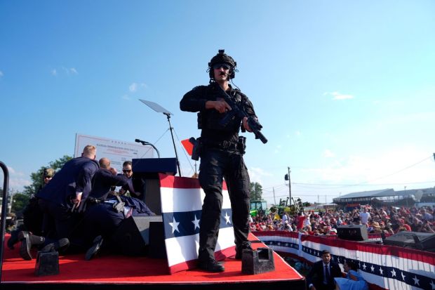 Former President Donald Trump is surrounded by U.S. Secret Service agents after he was shot at.(Photo: AP/PTI)