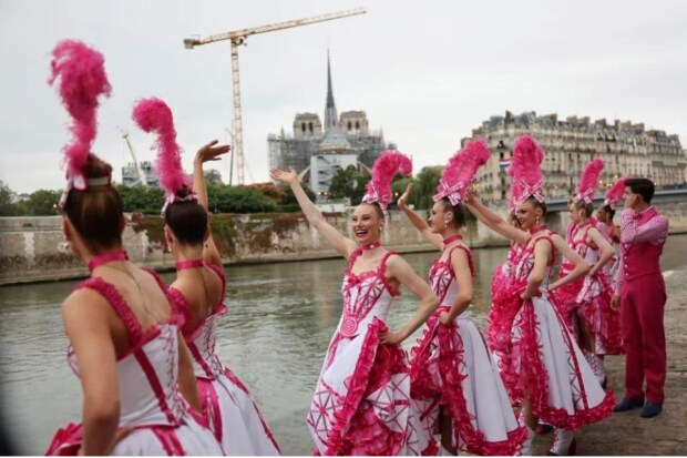 The event was punctuated with extravagant acts of various kinds, from Lady Gaga, cabaret artists, ballet dancers, and acrobats to a climax by Celine Dion, a faraway figure on stage halfway up the Eiffel Tower (AP)