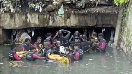 Workers cleaning the garbage accumulation in the canal