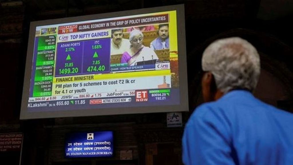 A man watches a screen displaying India's Finance Minister Nirmala Sitharaman's budget speech