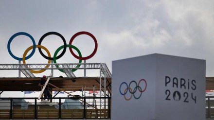 A worker finishes preparations at Eiffel Tower Stadium in Paris