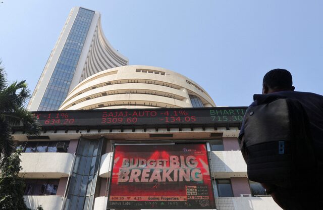 A man looks at a screen displaying budget news, on a facade of the Bombay Stock Exchange (BSE) building in Mumbai, India, February 1, 2022. REUTERS/File. A man looks at a screen displaying budget news, on a facade of the Bombay Stock Exchange (BSE) building in Mumbai, India, February 1, 2022. REUTERS/File.