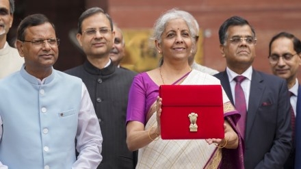 Union Finance Minister Nirmala Sitharaman showcases a tablet wrapped in a red pouch carrying the Budget documents, outside the Finance Ministry in North Block before leaving for the Parliament to table the Union Budget 2024-25, in New Delhi, Tuesday, July 23, 2024. (PTI Photo/Shahbaz Khan) Union Finance Minister Nirmala Sitharaman showcases a tablet wrapped in a red pouch carrying the Budget documents, outside the Finance Ministry in North Block before leaving for the Parliament to table the Union Budget 2024-25, in New Delhi, Tuesday, July 23, 2024. (PTI Photo/Shahbaz Khan)