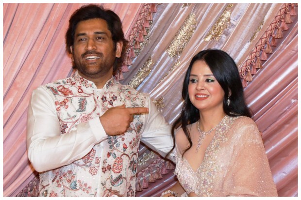 Former cricketer MS Dhoni getting candid with wife Sakshi Dhoni while posing for photos at Anant Ambani and Radhika Merchant’s sangeet ceremony ahead of their big fat wedding. (Image: PTI)