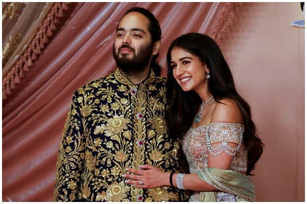 Anant Ambani, son of businessman Mukesh Ambani, poses with his fiance Radhika Merchant on the red carpet during the sangeet ceremony. (Image: Reuters/Francis Mascarenhas)