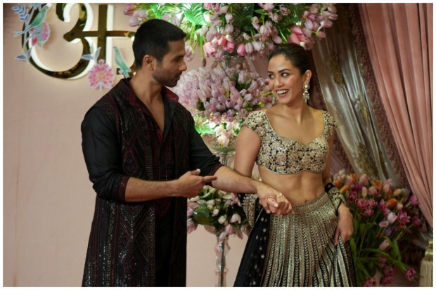 Stylish duo Shahid Kapoor and his wife Mira Rajput captured in a heartwarming moment at the red carpet laid out at Ambanis' sangeet ceremony. (Image: Reuters/Hemanshi Kamani)