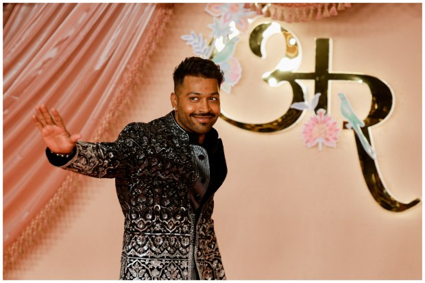 Indian cricketer Hardik Pandya gestures to the media as he arrives at the sangeet ceremony of Anant Ambani and Radhika Merchant at Jio World Centre, Mumbai. (Image: Reuters/Francis Mascarenhas)