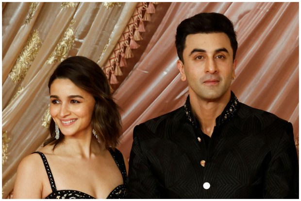 Bollywood's most loved couple Alia Bhatt and Ranbir Kapoor were seen posing arm in arm at the red carpet during the sangeet ceremony. (Image: Reuters/Francis Mascarenhas)