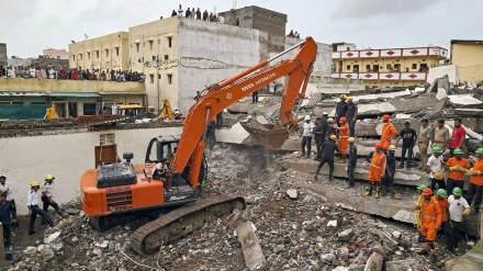 Officials and others during a rescue operation after a building collapse, in Surat district, Saturday, July 6, 2024. (PTI Photo)
