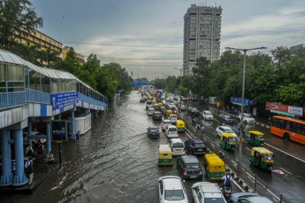 New Delhi: Vehicles ply on a waterlogged road after heavy rainfall. (PTI)