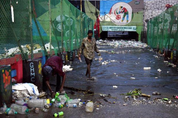 Hyderabad: Ragpickers collect reusable items from a flooded area after heavy monsoon rains. (PTI)