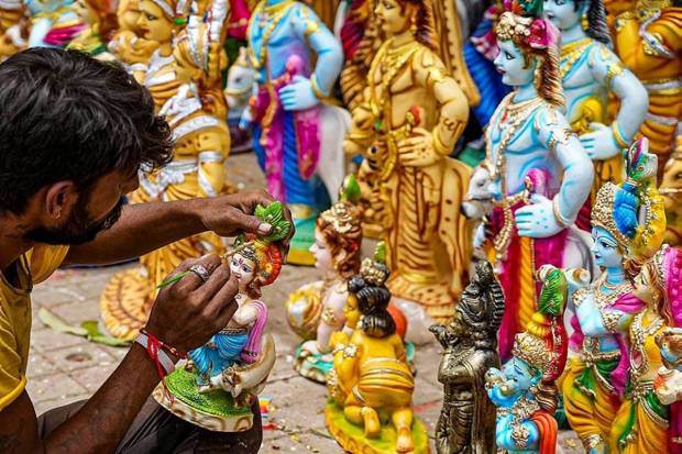 An artist giving final touches to an idol of Lord Krishna ahead in Bengaluru. (Photo source: PTI)