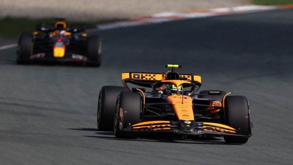 Lando Norris takes the chequered flag.